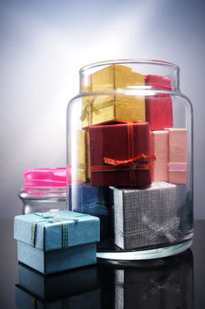 Bunch of gift boxes filling a glass flaskの写真素材