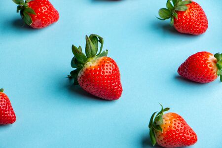 Heap of Fresh Strawberries on Light Blueの写真素材