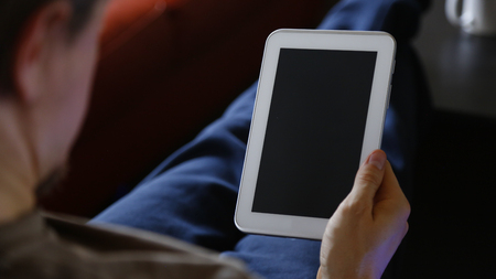 Man Using White Tablet with Black Screen