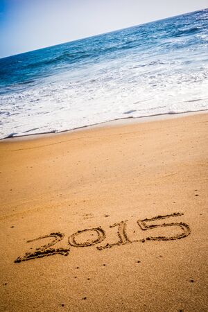 2015 written into the sand on a tropical sandy beach