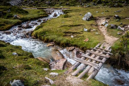 A wooden bridge on lush green landscape of Peru.の写真素材