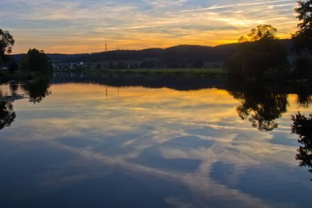 sunset next to Klardorf in bavaria, the village Bubach can be seen at the left sideの写真素材