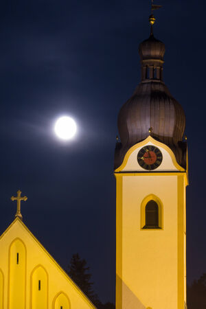 The church tower of Schwandorf with the moon behindの写真素材