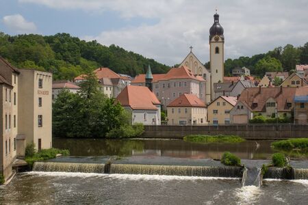 The city Schwandorf in Bavaria on a sunny day in spring. In the front the river Naabの写真素材