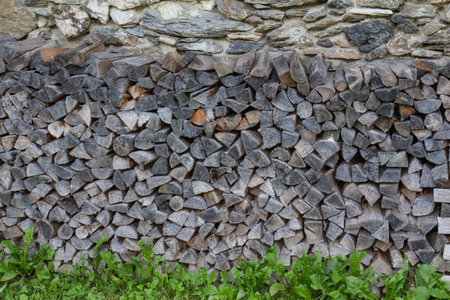 a stack firewood in front of a farmers house