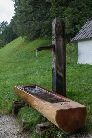 Wooden water through in the mountains, alpsの写真素材