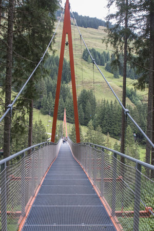Walkway inbetween the trees at the Talschluss in Saalbach Hinterglemm, the end of the valley, bridge over valleyの写真素材