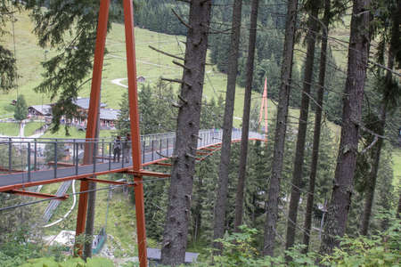 Walkway inbetween the trees at the Talschluss in Saalbach Hinterglemm, the end of the valley, bridge over valleyの写真素材