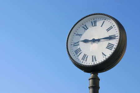 Street clock against blue sky with copy spaceの写真素材