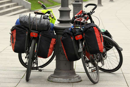 Two bicycles packet with travel bags resting on the city streetの写真素材
