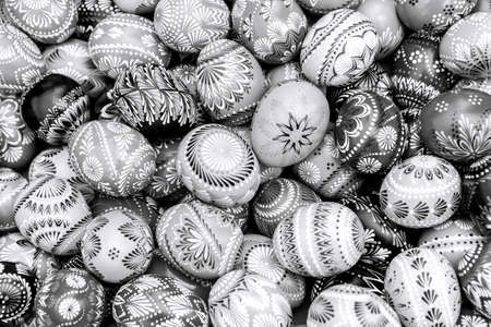 Black and white pile of decorated easter eggs, full frame backgroundの写真素材