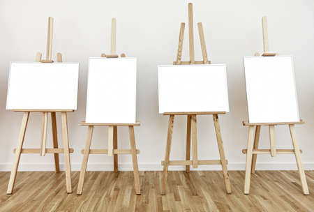 Four art studio easels with blank white frames to add paintings or pictures の写真素材