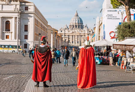 ROME, ITALY - DECEMBER 08, 2017: Two actors dressed as Roman Empire soldiers in streets of Rome, Italy, with St. Peters basilica in backgroundのeditorial素材