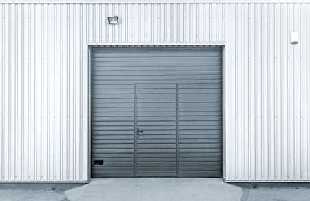 Closed modern steel garage or warehouse doors, colorized industrial pictureの写真素材