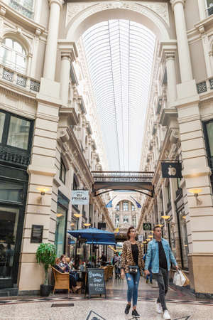 The Hague, Netherlands - August 24, 2018: The Passage shopping arcade interior in The Hague, Netherlands. Indoor picture with architectural roof detail, walking and sitting people.のeditorial素材