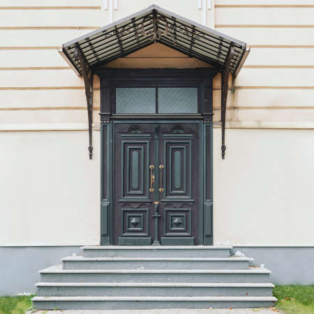 Classic style closed wooden doors, decorative outdoor entrance, front view building facadeの写真素材