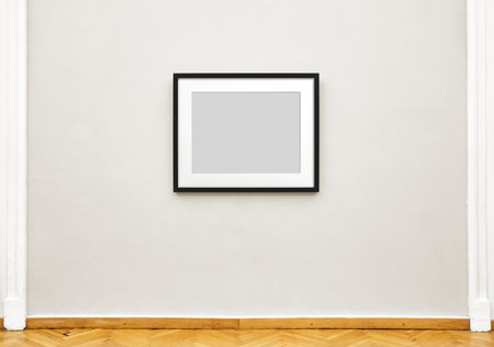 Black empty painting frame hanging on exhibition wall, front view museum expositionの写真素材