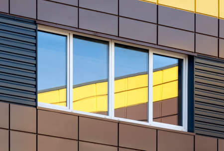 Abstract modern building exterior with colorful window reflection, contemporary architectureの写真素材