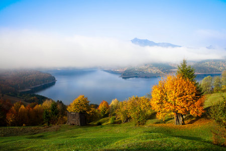 rural autumn landscape in Romanian Carpathians, Ceahlau mountain and Bicaz lakeの写真素材
