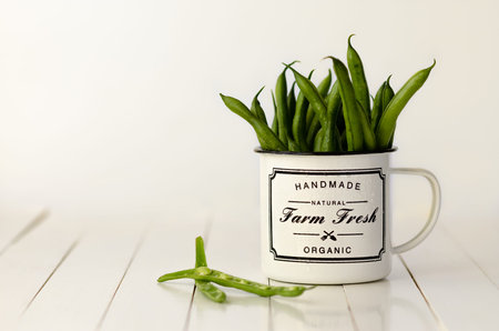 Green beans in a black and white mug.の写真素材