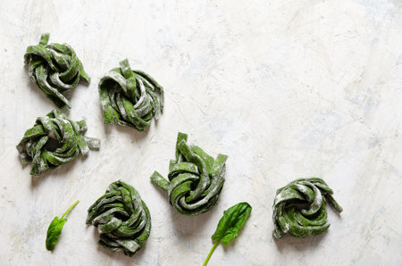 Spinach fettuccine on a light background.の写真素材