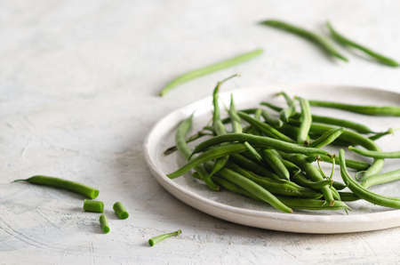 Green beans in a white dish on a white background.の写真素材