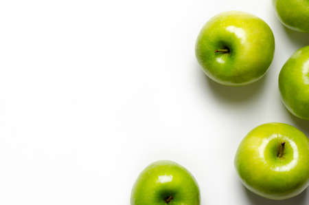 Green apples on white background with copy space.の写真素材