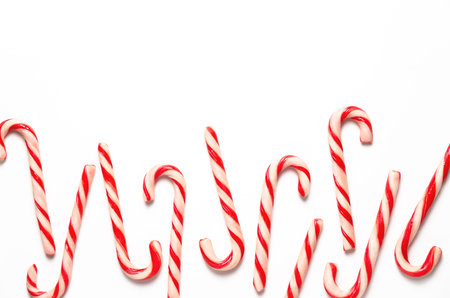 Christmas candy canes on white background with copy space.
