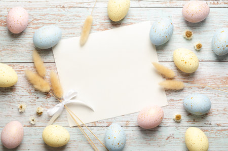 Easter greeting card with easter eggs and spikelets on wooden background with copy space.の写真素材