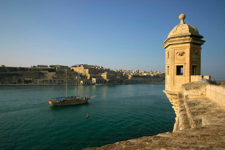 The Vedette in Senglea, Malta, overlooking a tourist schooner cruising along the Grand Harbour with...