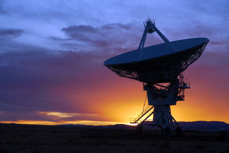 Silhouette of a radio telescope at the Very Large Array (VLA) in New Mexico, USA, at sunsetの写真素材