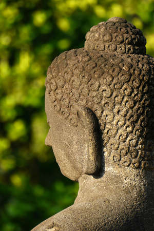 Close-up of the head of one of the many Buddha statues found at the ancient temple of Borobudur, Java, Indonesiaの写真素材