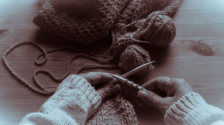 Homemade cozy sweater knitting .Human hands .Monochrome toned.の写真素材