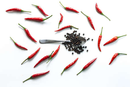Fresh red hot thai chili and pepper in spoon on white backgroundの写真素材