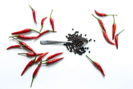 Fresh red hot thai chili and pepper in spoon on white backgroundの写真素材
