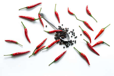 Fresh red hot thai chili and pepper in spoon on white backgroundの写真素材
