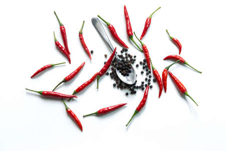 Fresh red hot thai chili and pepper in spoon on white backgroundの写真素材