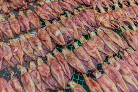 dry squids on sale, in the market of Thailandの写真素材