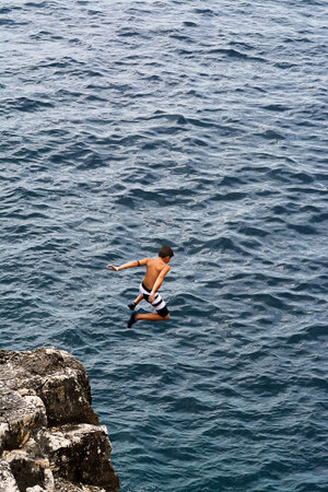 Boy plunges off a cliff very highの写真素材