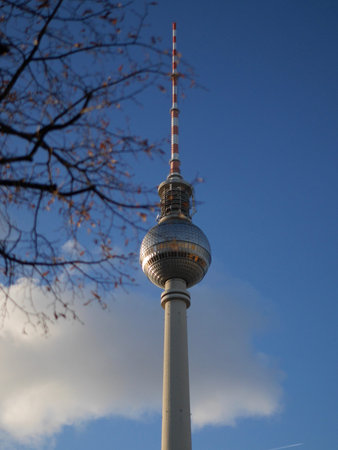 View of the Fernsehturm TV Tower, Berlin, Germany with its revolving restaurant in the Sphere and communications antenna against a blue skyのeditorial素材