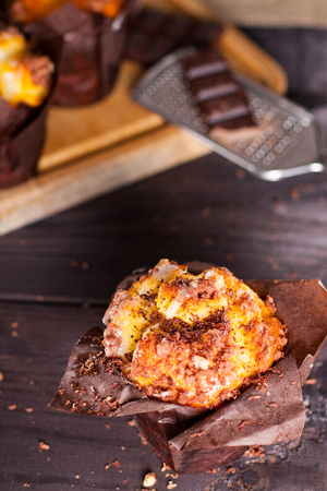 Muffins with chocolate on wooden background.の写真素材