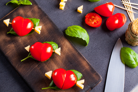 Marinated fillet with tomato heart shaped.  Appetizer for a party. Valentine's Day treat for your loved one.の写真素材