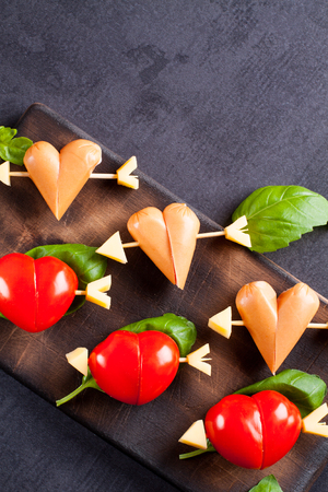 Marinated fillet with tomato and sausage heart shaped.  Appetizer for a party. Valentine's Day treat for your loved one.の写真素材