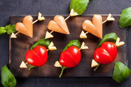 Marinated fillet with tomato and sausage heart shaped.  Appetizer for a party. Valentine's Day treat for your loved one.の写真素材