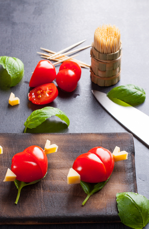 Marinated fillet with tomato heart shaped.  Appetizer for a party. Valentine's Day treat for your loved one.の写真素材