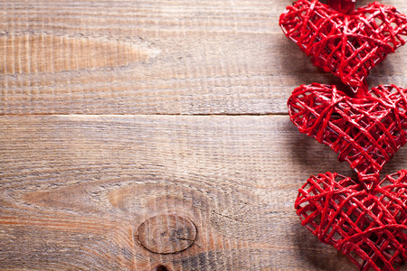 Red hearts on wooden background. Symbol of love in valentine's day.の写真素材
