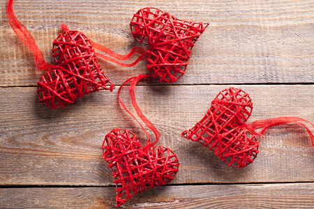 Red hearts on wooden background. Symbol of love in valentine's day.の写真素材