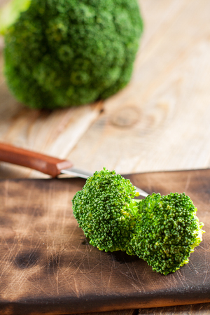 Raw green broccoli on wooden backgroundの写真素材