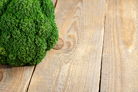 Raw broccoli on wooden background with copy space.の写真素材