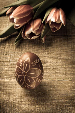 Easter egg and tulips on wooden background.の写真素材